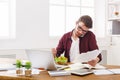 Busy man has business lunch in modern office interior Royalty Free Stock Photo