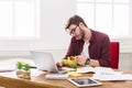 Busy man has business lunch in modern office interior Royalty Free Stock Photo