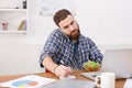 Busy man has vegetarian lunch in modern office interior Royalty Free Stock Photo