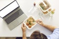 Busy man having lunch break at office desk with laptop computer with blank copy space screen Royalty Free Stock Photo