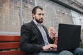 Busy man is in a hurry, he does not have time, he is going to eat snack on the go. Worker eating, drinking coffee Royalty Free Stock Photo