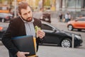 Busy man is in a hurry, he does not have time, he is going to eat snack on the go. Worker eating, drinking coffee Royalty Free Stock Photo