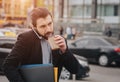 Busy man is in a hurry, he does not have time, he is going to eat snack on the go. Worker eating, drinking coffee Royalty Free Stock Photo