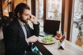 Busy man is in a hurry, he does not have time, he is going to eating and working. Worker eating, drinking coffee Royalty Free Stock Photo