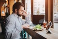 Busy man is in a hurry, he does not have time, he is going to eating and working. Worker eating, drinking coffee Royalty Free Stock Photo