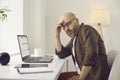 Busy man overwhelmed with work using calendar on laptop and planning his schedule Royalty Free Stock Photo