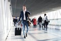 Busy man speaking on phone and walking in airport Royalty Free Stock Photo