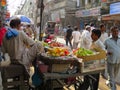 Busy market scene old Delhi India . Fruit seller.