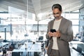 Busy mature business man wearing suit using mobile cell phone in office.