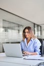 Busy mature business woman using laptop working in office. Vertical Royalty Free Stock Photo