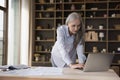 Busy mature elderly entrepreneur woman using laptop computer Royalty Free Stock Photo