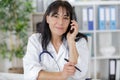 Busy medical doctor on phone with receptionist Royalty Free Stock Photo