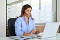 Busy mature woman professional call contact center agent working in office. Royalty Free Stock Photo