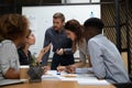 Busy millennial group of motivated mixed race teammates discussing project. Royalty Free Stock Photo