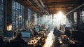 Busy modern office workspace with employees working at computers in industrial loft setting. Sunlight streaming through large Royalty Free Stock Photo