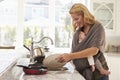 Busy Mother With Baby In Sling Multitasking At Home Royalty Free Stock Photo