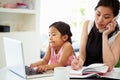 Busy Mother Working From Home With Daughter Royalty Free Stock Photo