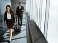Busy is the new happy. two executive businesspeople walking through an airport during a business trip. Royalty Free Stock Photo