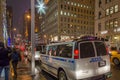 Busy New York City Manhattan Avenue with Traffic Jam During Night Time. NYPD Police Vehicles Patroling the Neighborhood