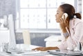Busy office girl on phone Royalty Free Stock Photo