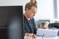 A busy office woman eats ice cream at her workplace without interrupting work Royalty Free Stock Photo