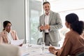 Busy older leader and company employees at business meeting discussing work. Royalty Free Stock Photo