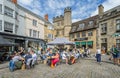 Busy outdoor cafes in front of the Penniless Porch in Market Place, Wells, Somerset, UK