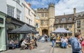 Busy outdoor cafes in front of the Penniless Porch in Market Place, Wells, Somerset, UK