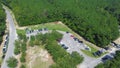 Busy parking at the entrance of Morrison Springs County Park surrounding by lush green bald cypress trees in Walton County,