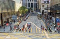 Busy pedestrian and car crossing at Hong Kong