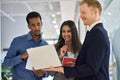 Busy professional diverse team people standing in office looking at laptop. Royalty Free Stock Photo