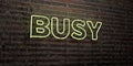 BUSY -Realistic Neon Sign on Brick Wall background - 3D rendered royalty free stock image