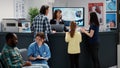 Busy reception desk with many patients coming to fill in report Royalty Free Stock Photo