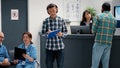 Busy receptionist giving assistance to diverse group of patients Royalty Free Stock Photo