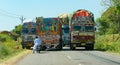 Busy road in India, with trucks and motorcycle