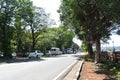 A busy road with normal traffic in goa with tress beside