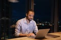 African businessman stay late in modern office working using laptop Royalty Free Stock Photo