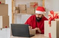 busy Santa Clause packing gift boxes preparing fast xmas delivery. funny Santa in workshop warehouse in Merry Christmas