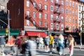 Busy scene with crowds of people walking through an intersection on 7th Avenue in New York City