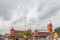 Busy scene in front of famous ancient railway station,vehicles pass by traffic signal,people are waiting to cross the road Royalty Free Stock Photo