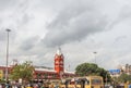 Busy scene in front of famous ancient railway station,vehicles pass by traffic signal,people are waiting to cross the road Royalty Free Stock Photo