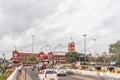 Busy scene in front of famous ancient railway station,vehicles pass by traffic signal,people are waiting to cross the road Royalty Free Stock Photo