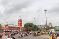 Busy scene in front of famous ancient railway station,vehicles pass by traffic signal,people are waiting to cross the road Royalty Free Stock Photo