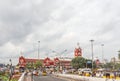 Busy scene in front of famous ancient railway station,vehicles pass by traffic signal,people are waiting to cross the road Royalty Free Stock Photo