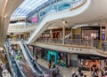 Busy scene with shoppers on escalators inside the Bullring Shopping Mall in Birmingham, West Midlands, UK