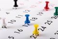 Busy schedule - colorful pins on a calendar Royalty Free Stock Photo