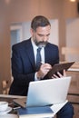 Busy senior business man in a coffee shop Royalty Free Stock Photo