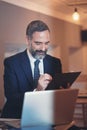 Busy senior business man in a coffee shop Royalty Free Stock Photo