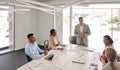 Busy senior manager leading business team meeting in office board room. Royalty Free Stock Photo