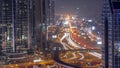 Busy Sheikh Zayed Road aerial all night timelapse, metro railway and modern skyscrapers around in luxury Dubai city. Royalty Free Stock Photo